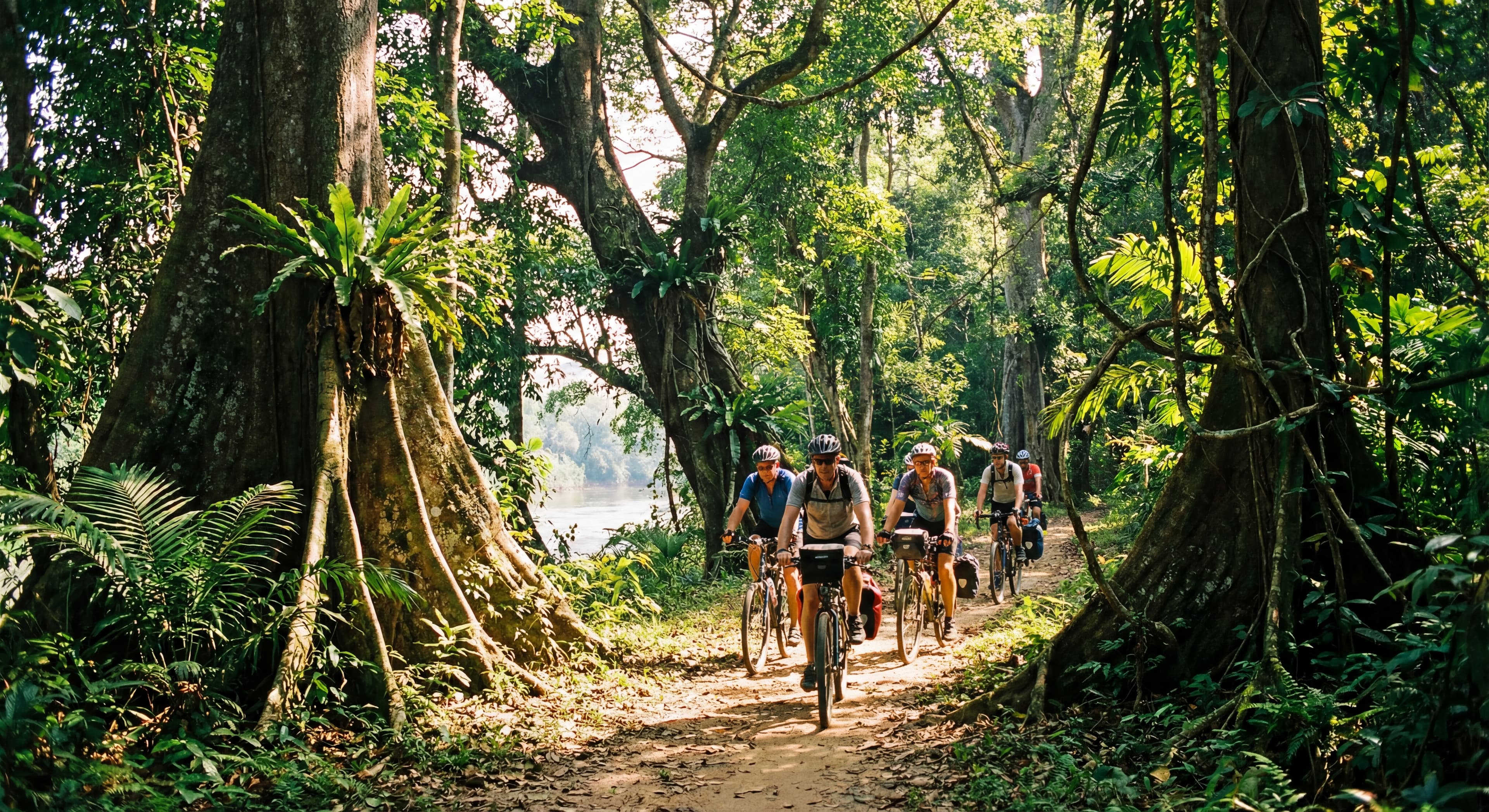 Cyclists riding through a scenic forest path in Cát Tiên National Park, surrounded by lush greenery 
